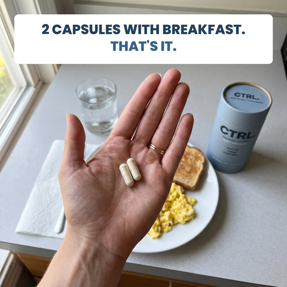 Two CTRL capsules in a palm over breakfast