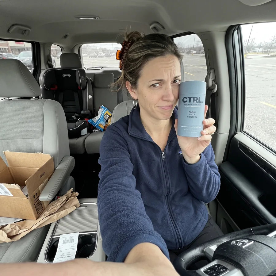 Megan in her car giving the CTRL tube a skeptical look after it arrived in the mail