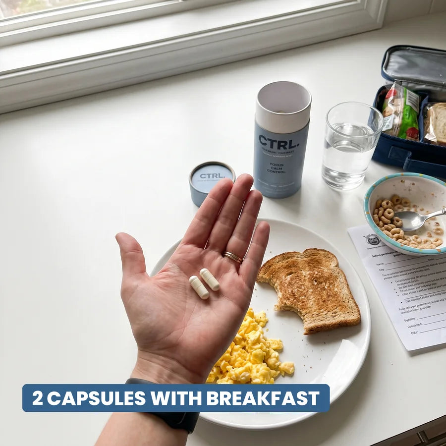 Two CTRL capsules in a palm over a breakfast plate, the tube beside it