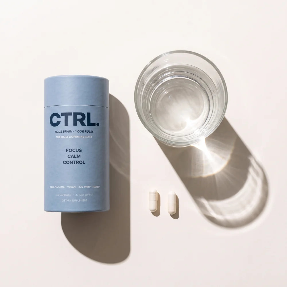 CTRL Dopamine Capsules tube with two capsules and a glass of water