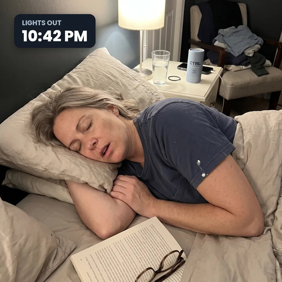 Woman fast asleep at 10:42pm with a book on the duvet and CTRL on the nightstand