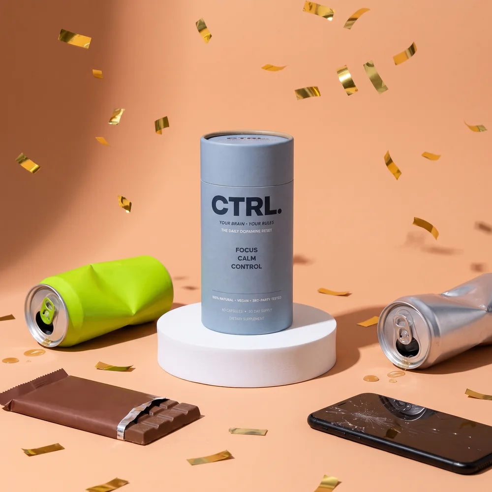 The CTRL tube standing in a boxing ring as the winner, with an energy drink, a candy bar and a phone knocked out
