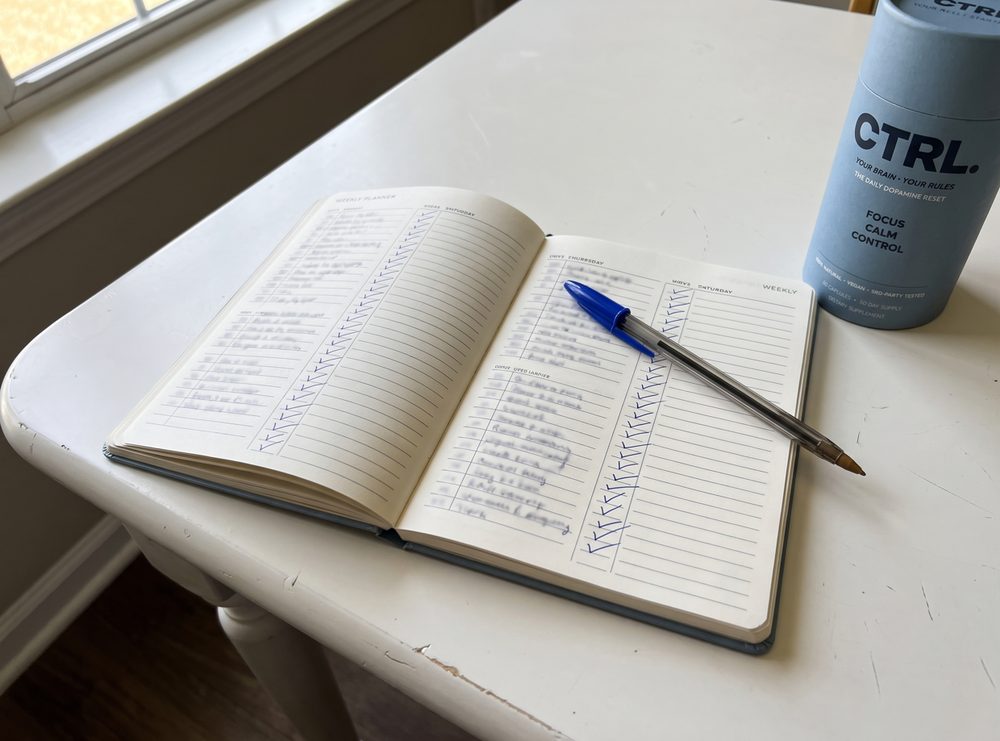 A weekly planner with every task ticked off, CTRL beside it